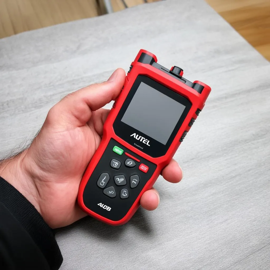 Autel 808 scanner being held in hand