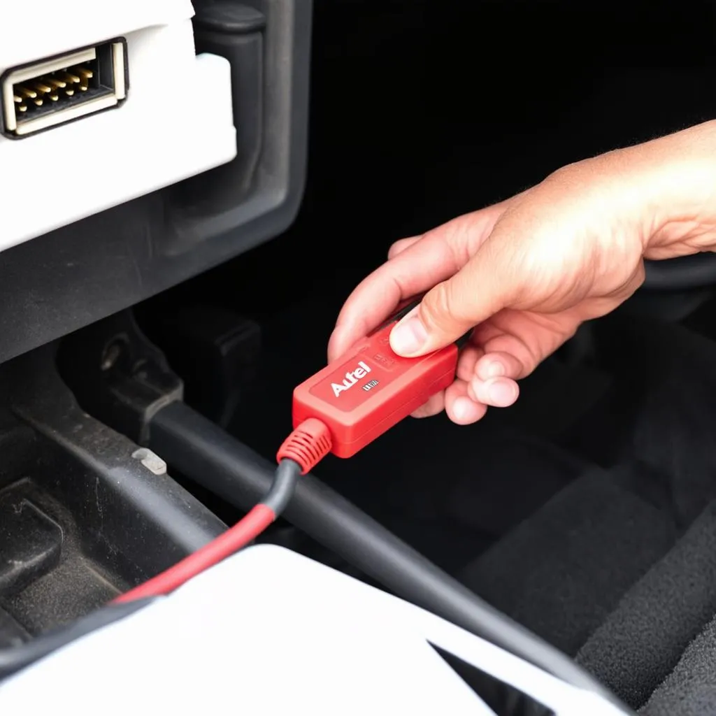 Autel AA101 cable connected to a car