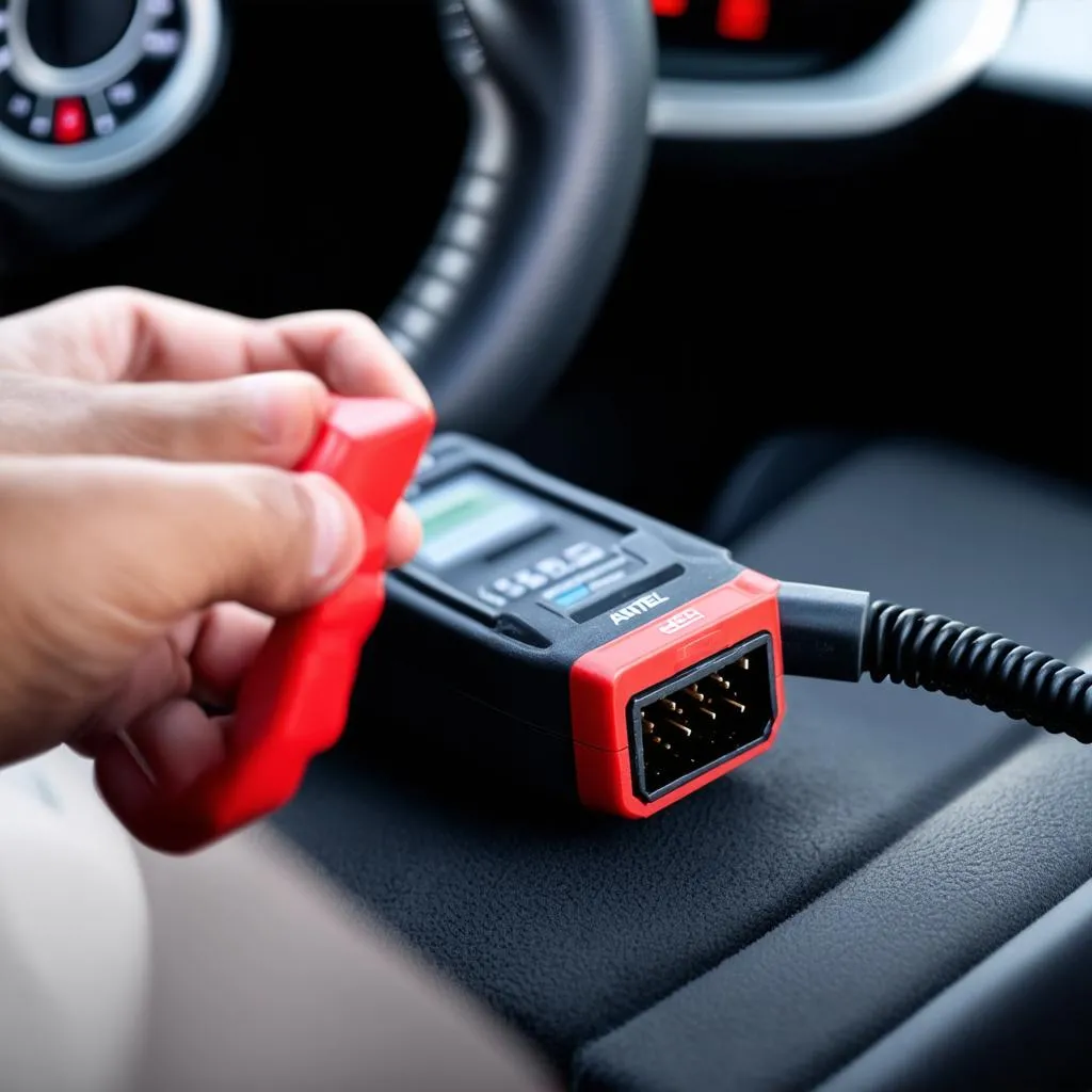 Autel Code Reader plugged into a car's OBD2 port