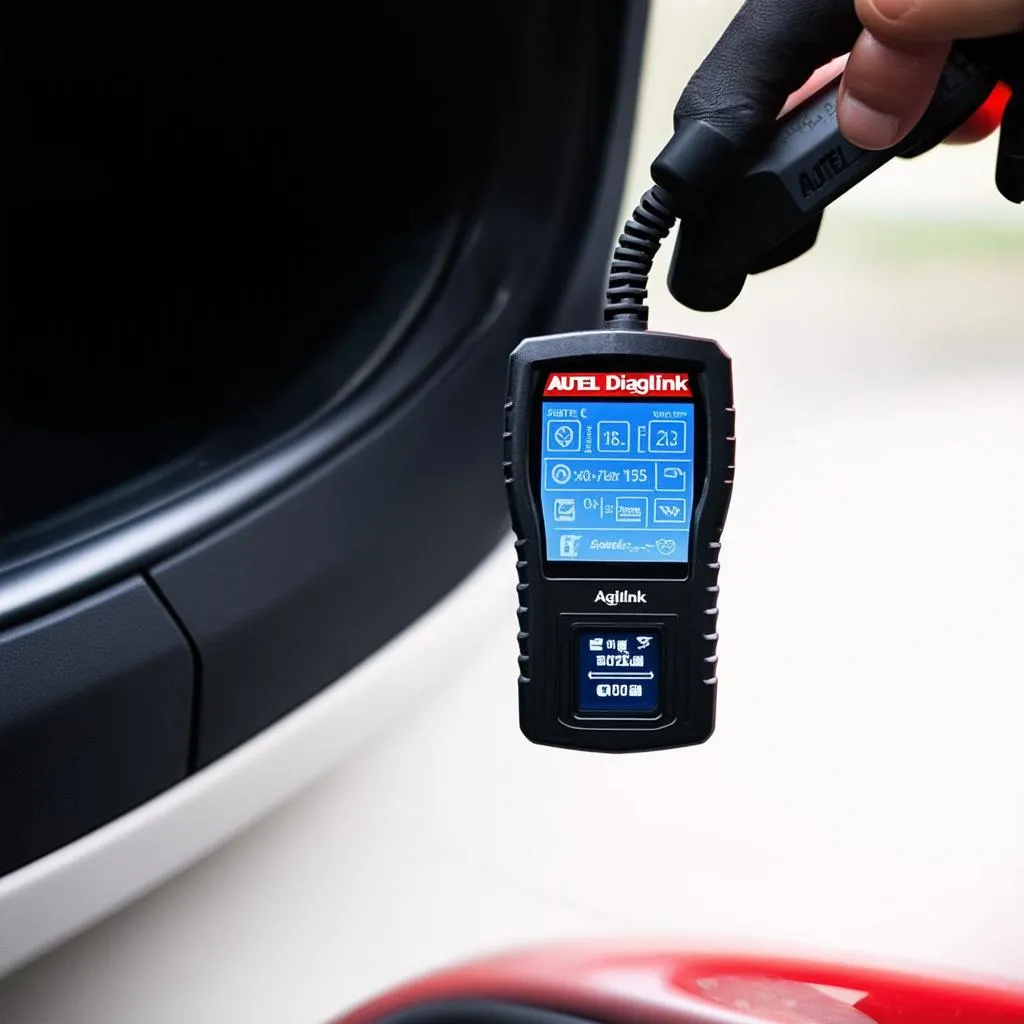 Autel Diaglink OBDII code reader plugged into a car's OBDII port