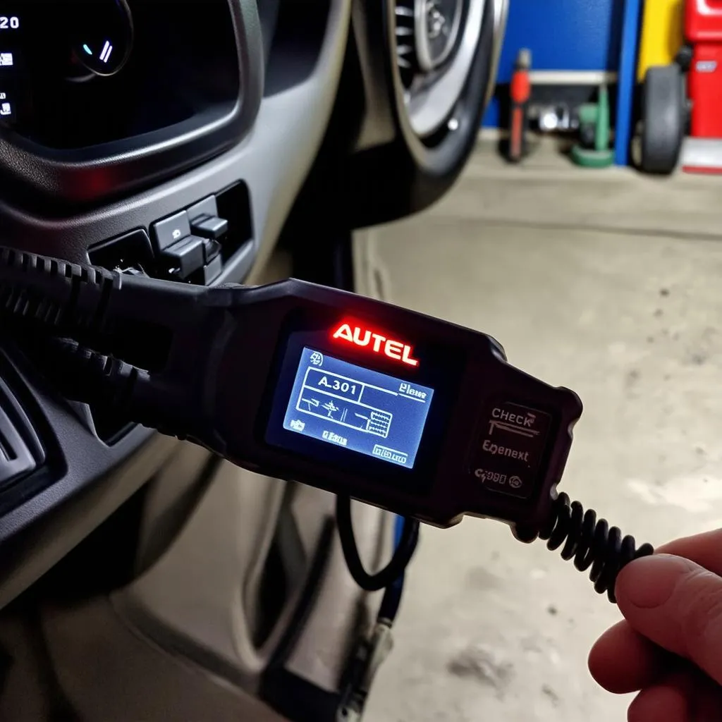 Autel AL301 OBD2 Scanner plugged into a car's OBD2 port