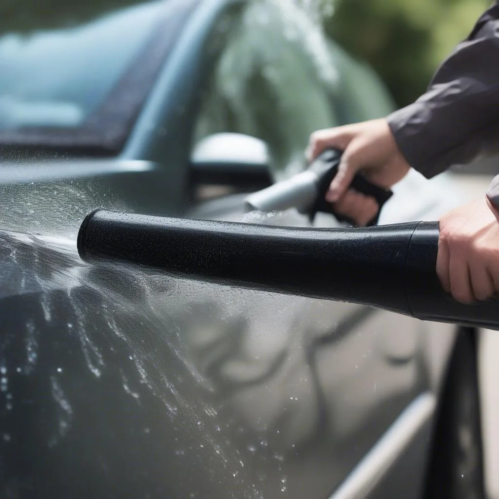 Leaf blower drying a car