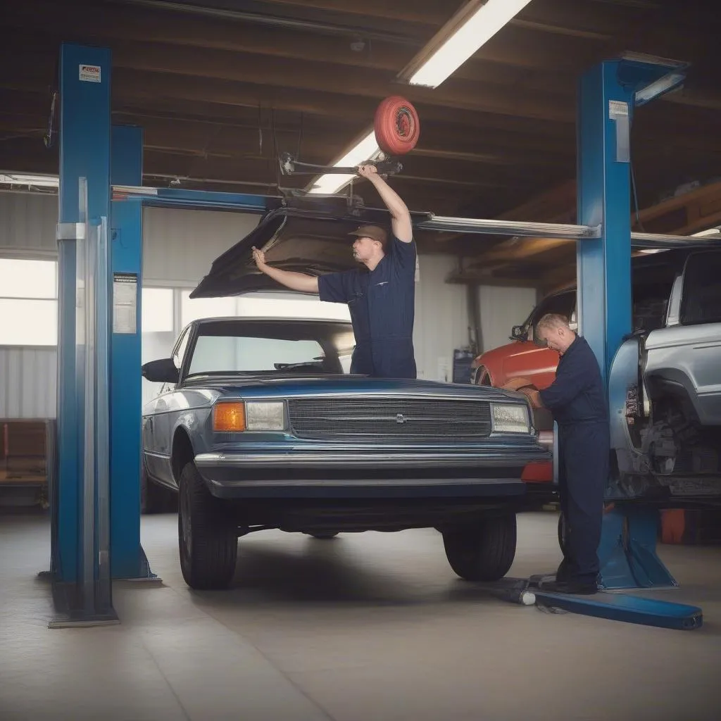 Mechanic using a lift to work under a car