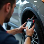 Nissan dealership technician using a dealer scanner to diagnose an electrical issue