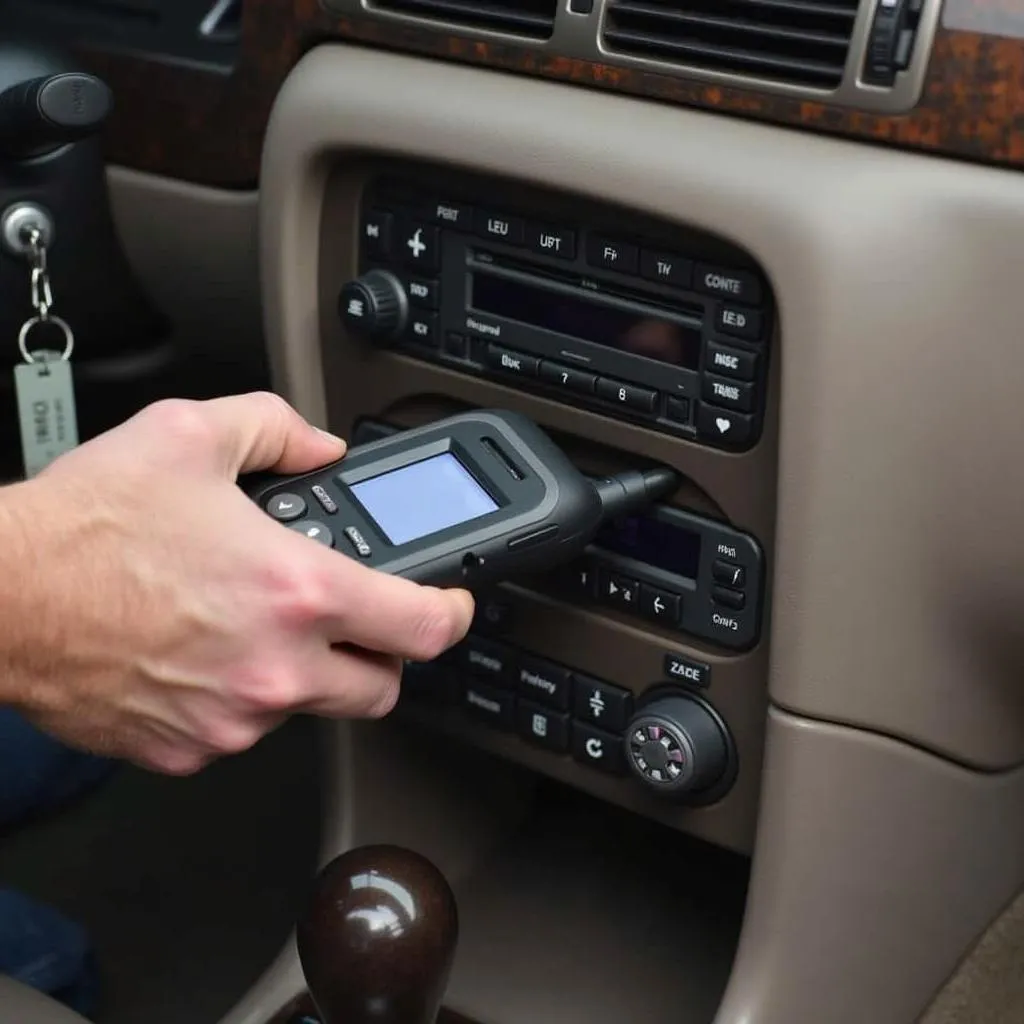 Mechanic using a scan tool to program a key fob for a 2002 Buick LeSabre