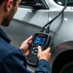 Mechanic using a scan tool to reset the oil life monitor on a car