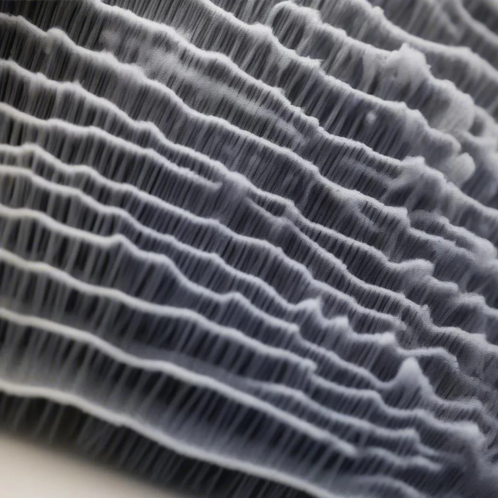 A close-up shot of a tower car wash brush, highlighting its softness and microfiber material.