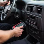 Mechanic Checking OBD-II Port Connection on a 2000 Suburban