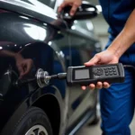 Mechanic connecting a computer diagnostic tool to a car's OBD2 port