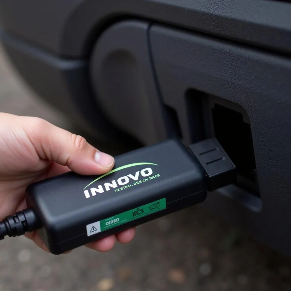 Innova CarScan plugged into a car's OBD2 port