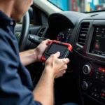 Mechanic connecting a PC scan tool to a car's OBD-II port