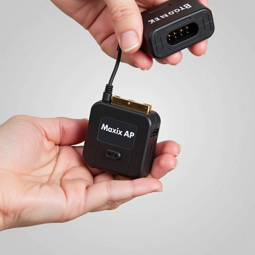 A person holding the Autel MaxiAP AP200 OBD2 adapter.