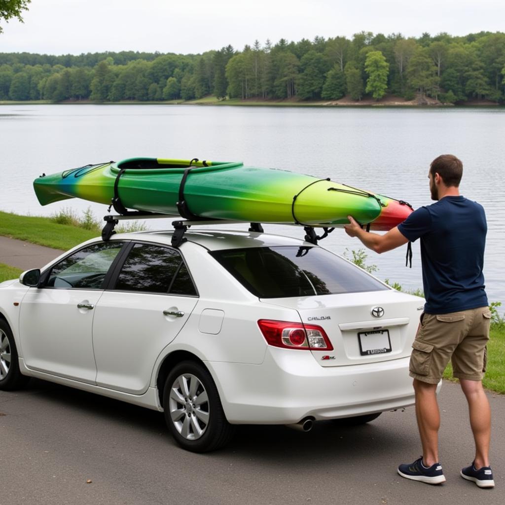 Kayaker Loading Kayak onto Car Roof with Roller