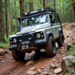 Land Rover Defender tackling a challenging off-road terrain